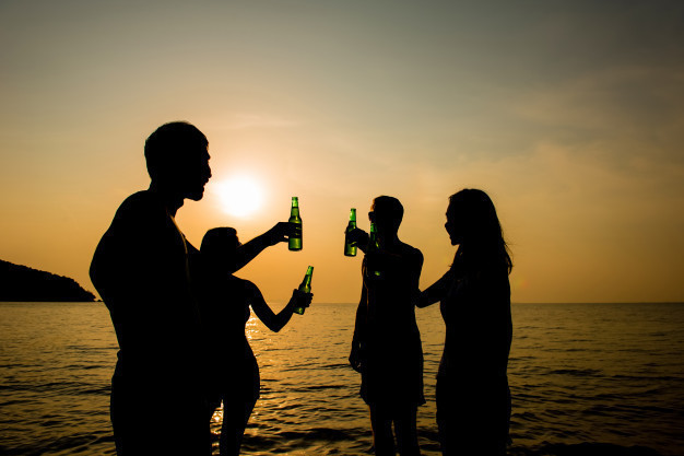 group-young-friends-drinking-having-party-beach-evening-sunset_8087-3131.jpg